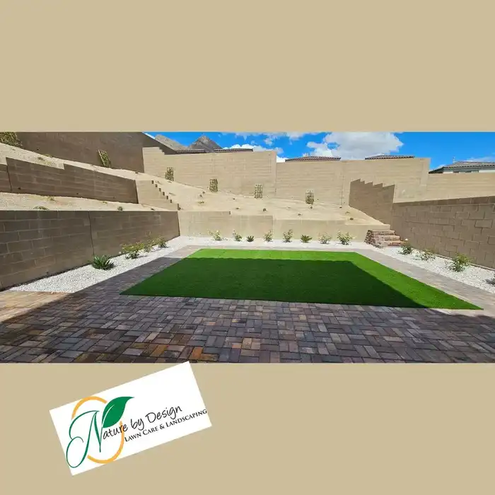 Paver patio with turf inlay and tiered retaining walls