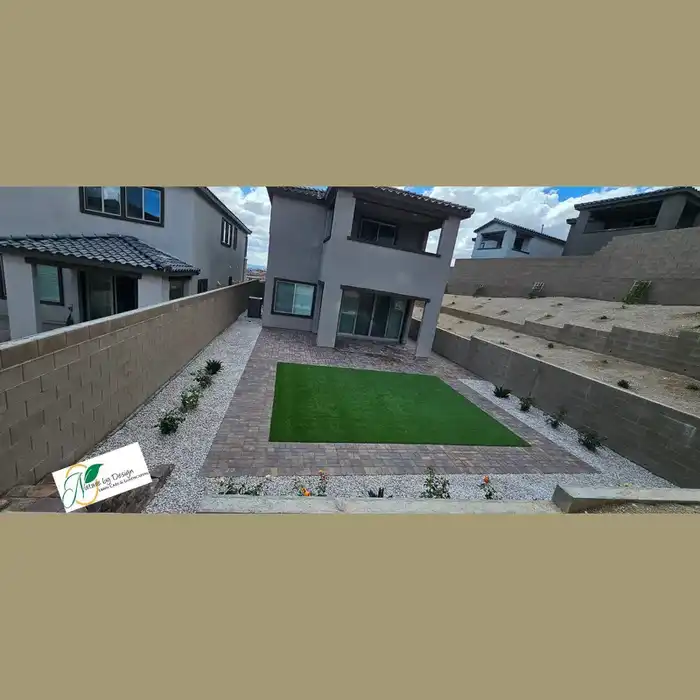 Modern backyard with pavers, turf square, and desert landscaping